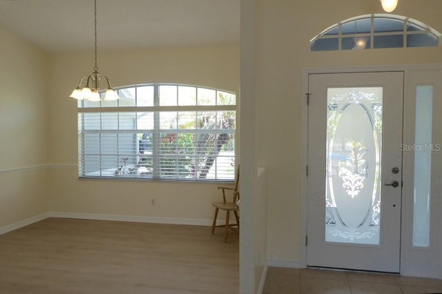 328 Baytree Dr, Rotonda West, FL 33947 - foyer entrance with a chandelier, wood finished floors, and baseboards