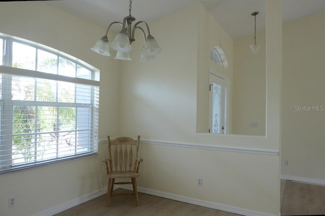328 Baytree Dr, Rotonda West, FL 33947 - unfurnished room with a chandelier, wood finished floors, and baseboards