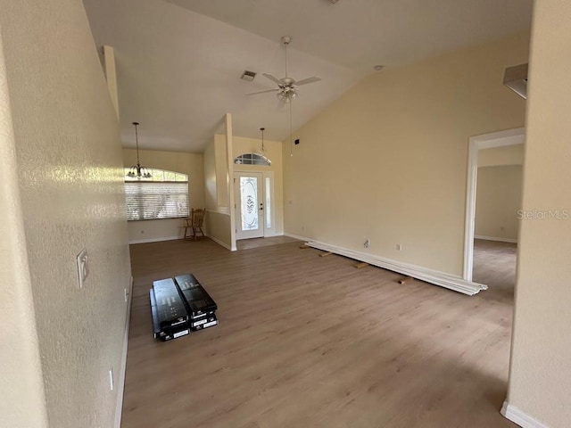 328 Baytree Dr, Rotonda West, FL 33947 - unfurnished living room featuring lofted ceiling, wood finished floors, ceiling fan, and baseboards