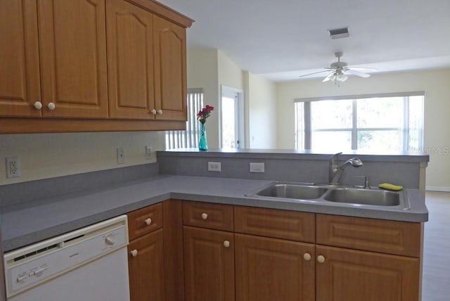 328 Baytree Dr, Rotonda West, FL 33947 - kitchen with dishwasher, a sink, a peninsula, ceiling fan, and brown cabinetry