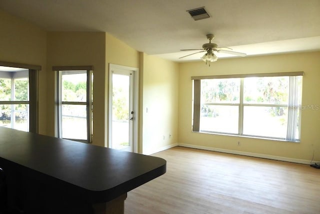 328 Baytree Dr, Rotonda West, FL 33947 - living room featuring light wood finished floors, a ceiling fan, and healthy amount of natural light