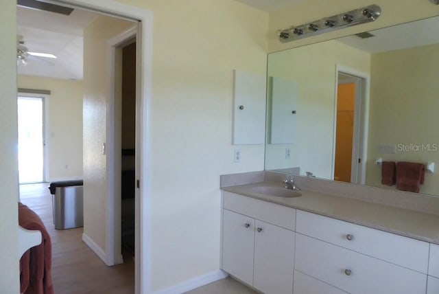328 Baytree Dr, Rotonda West, FL 33947 - bathroom featuring vanity, a ceiling fan, baseboards, and wood finished floors