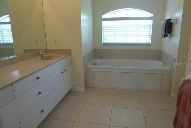 328 Baytree Dr, Rotonda West, FL 33947 - full bath featuring tile patterned floors, vanity, a garden tub, and plenty of natural light