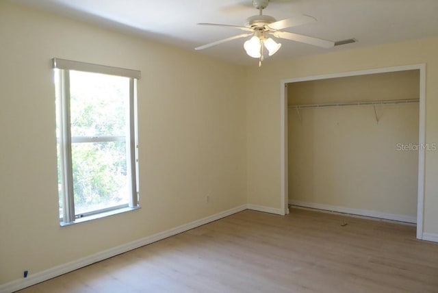328 Baytree Dr, Rotonda West, FL 33947 - unfurnished bedroom with wood finished floors, a closet, baseboards, and a ceiling fan