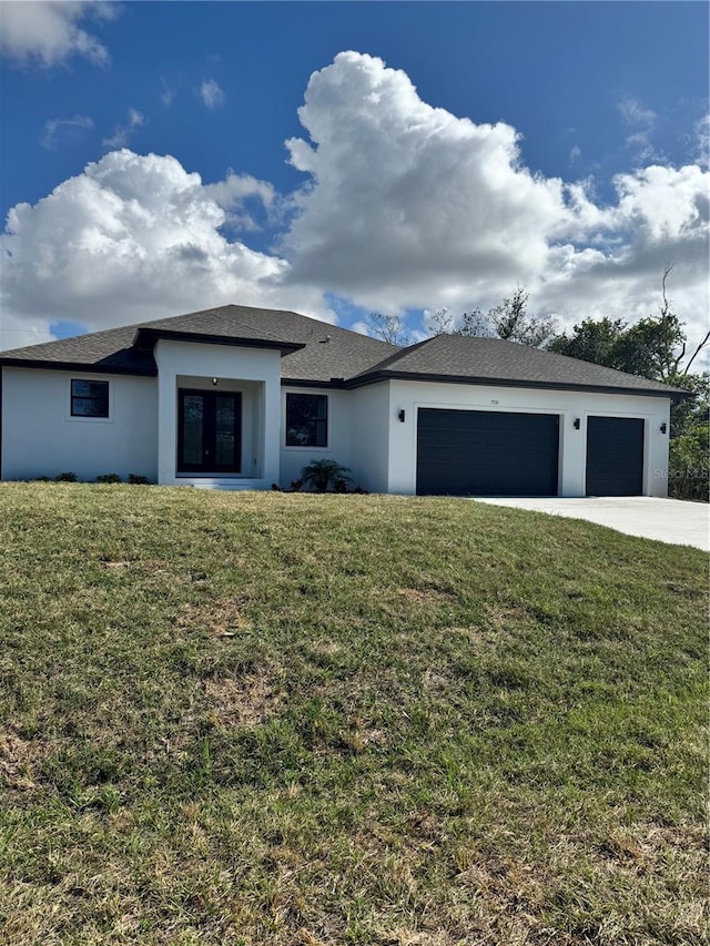 view of front of house with a garage and a front yard