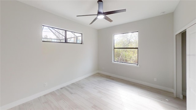 unfurnished bedroom with multiple windows, ceiling fan, and light wood-type flooring