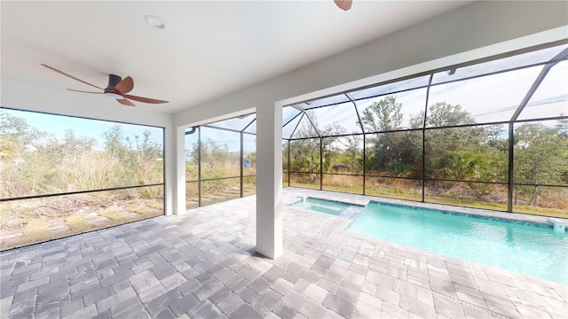 view of pool featuring a lanai, a patio, ceiling fan, and an in ground hot tub