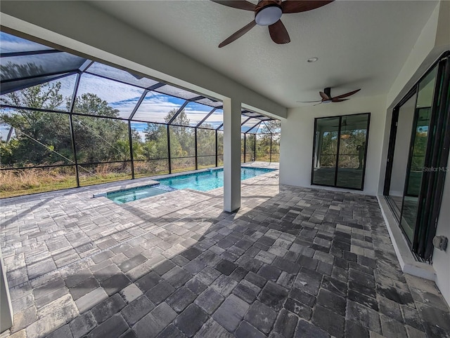 view of pool featuring a lanai, a patio, and ceiling fan