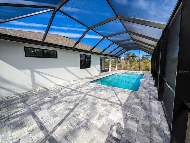 view of pool with a lanai and a patio