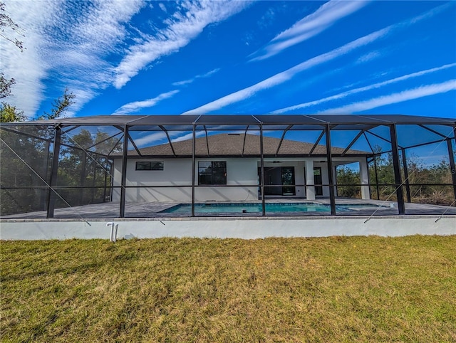 back of house with a yard, a patio area, and glass enclosure