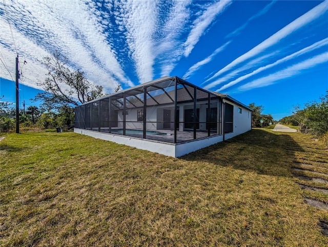 rear view of property with a lanai, a swimming pool, and a lawn