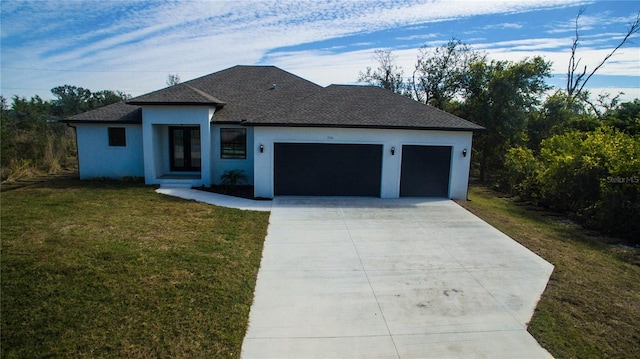 view of front of property featuring a garage and a front lawn