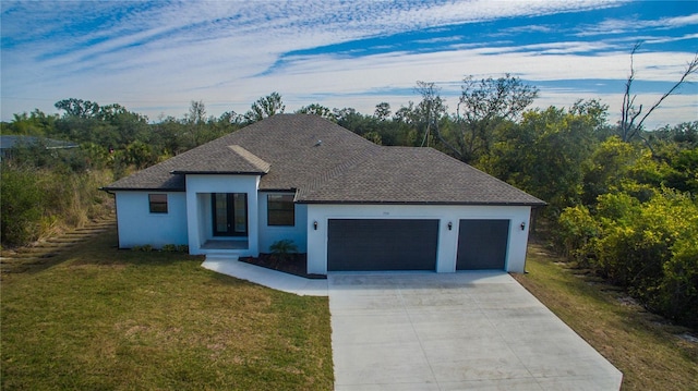 view of front of house with a garage and a front lawn