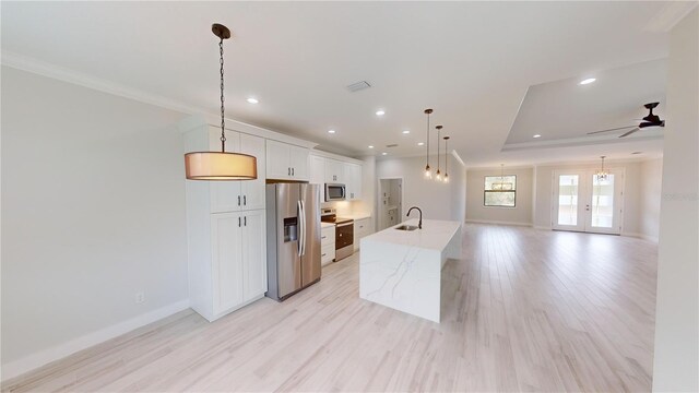 7330 Printer St, Port Charlotte, FL 33981 - kitchen featuring stainless steel appliances, a sink, ornamental molding, a kitchen island with sink, and baseboards