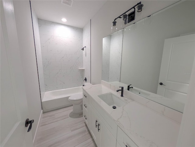 7330 Printer St, Port Charlotte, FL 33981 - bathroom with vanity, toilet, shower / bathtub combination, wood finished floors, and recessed lighting