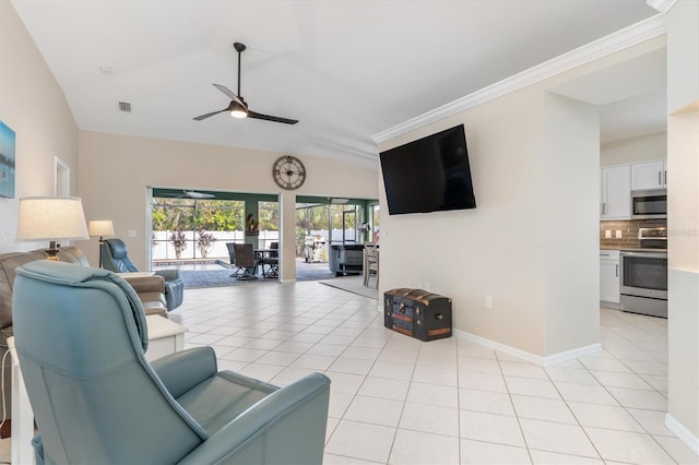 tiled living room with ceiling fan and vaulted ceiling