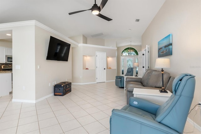 tiled living room featuring ceiling fan, crown molding, and vaulted ceiling