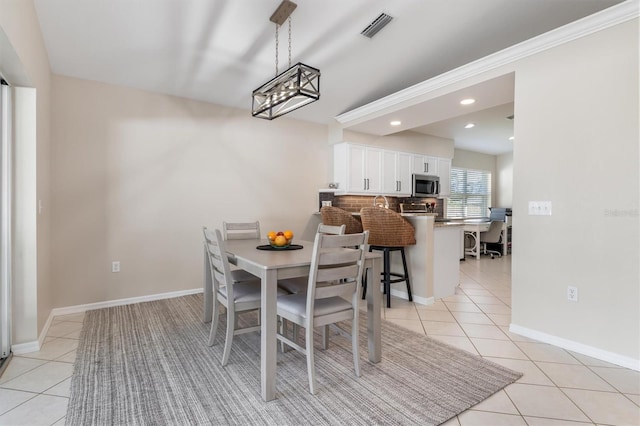 dining space featuring light tile patterned floors