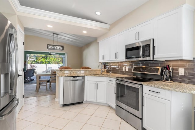 kitchen with white cabinets, decorative backsplash, sink, and appliances with stainless steel finishes