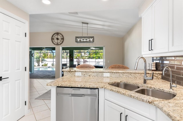 kitchen featuring white cabinetry, dishwasher, lofted ceiling, and sink