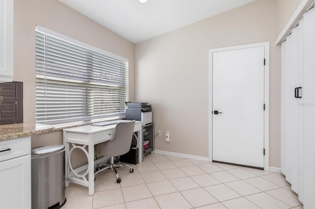 home office featuring light tile patterned floors and lofted ceiling