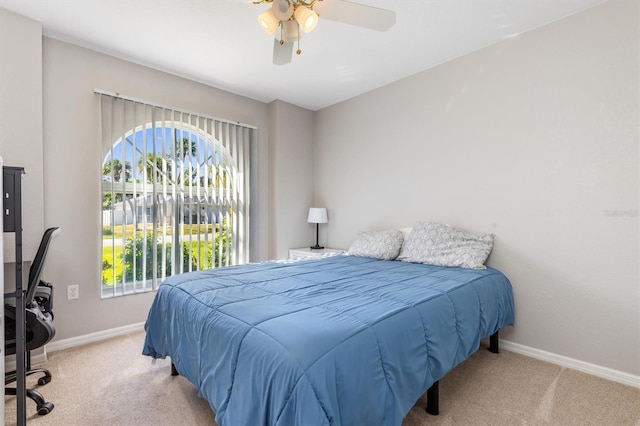 bedroom featuring ceiling fan and light colored carpet