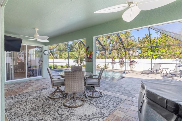 sunroom featuring a wealth of natural light and ceiling fan