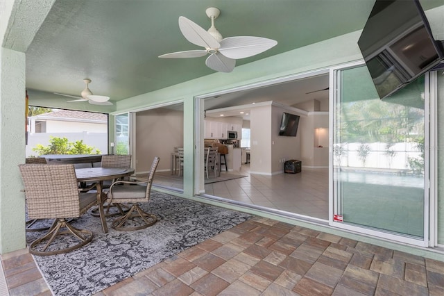 sunroom with ceiling fan and a healthy amount of sunlight