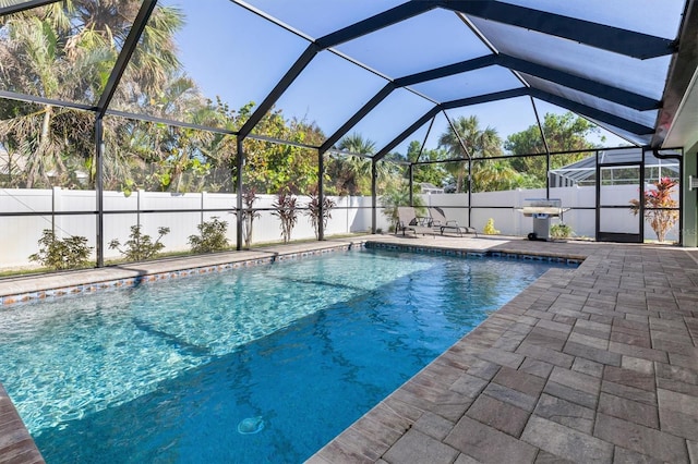 view of swimming pool with a lanai and a patio