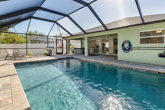 view of pool with a lanai, a patio area, and ceiling fan