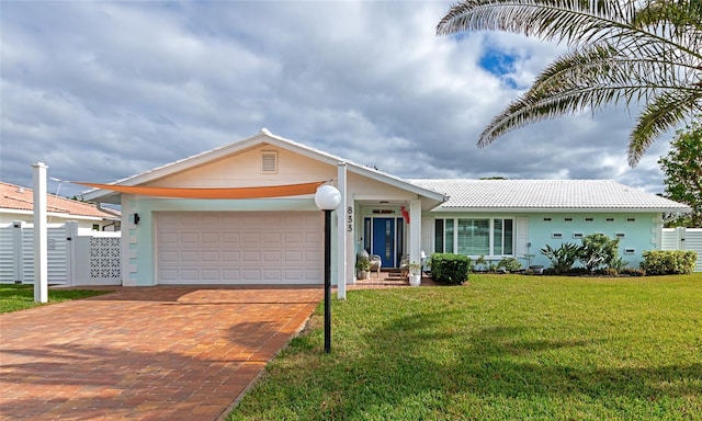 single story home with a garage and a front yard