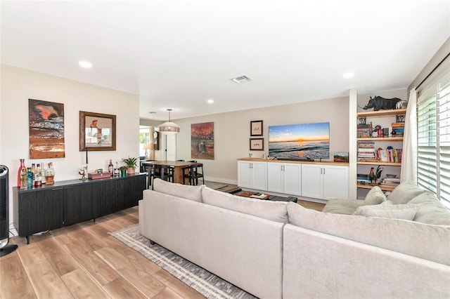 living room featuring plenty of natural light and light hardwood / wood-style floors