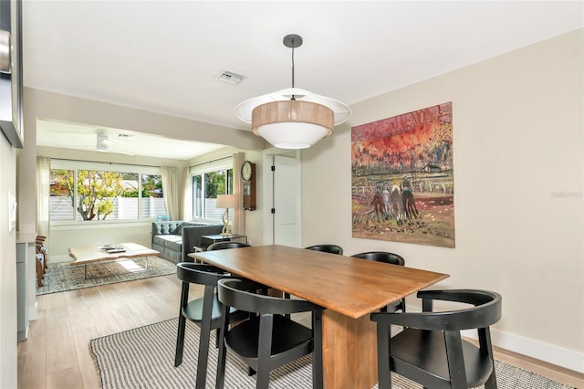 dining space with light hardwood / wood-style flooring