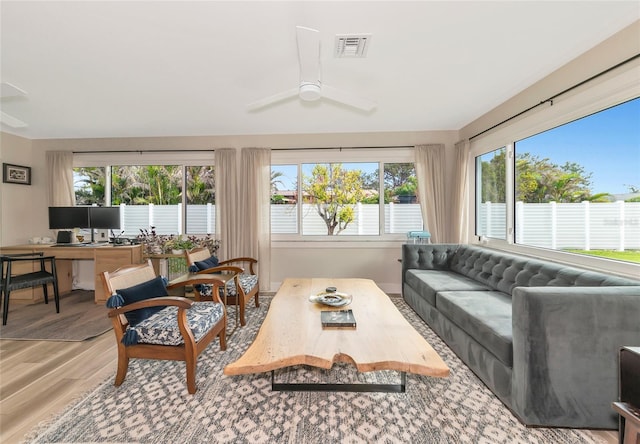 sunroom / solarium with a wealth of natural light and ceiling fan