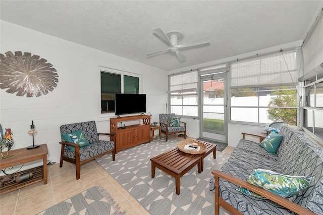 sunroom / solarium featuring ceiling fan