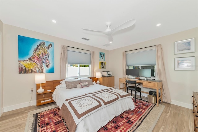 bedroom with ceiling fan and light hardwood / wood-style flooring