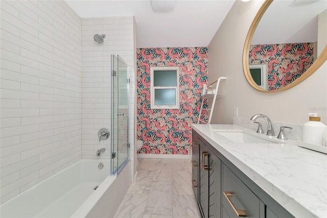 full bathroom with toilet, vanity, and tiled shower / bath combo