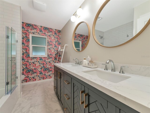 bathroom featuring vanity and combined bath / shower with glass door