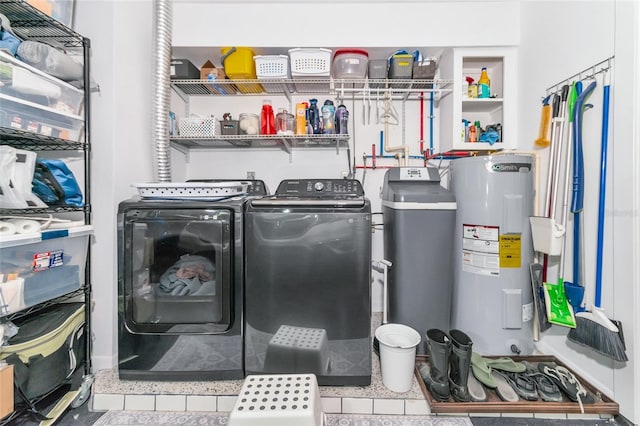 washroom featuring tile patterned flooring, independent washer and dryer, and electric water heater