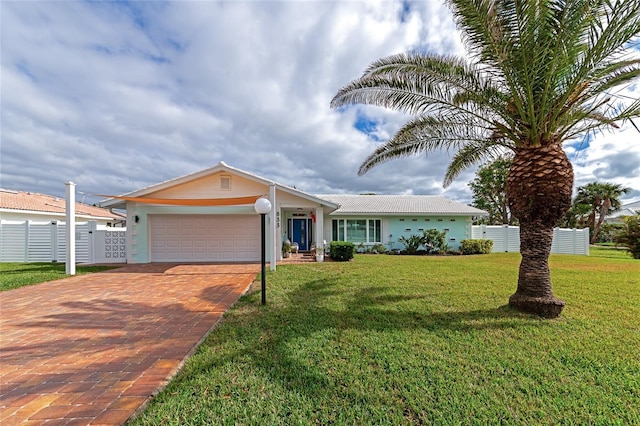 single story home with a front yard and a garage