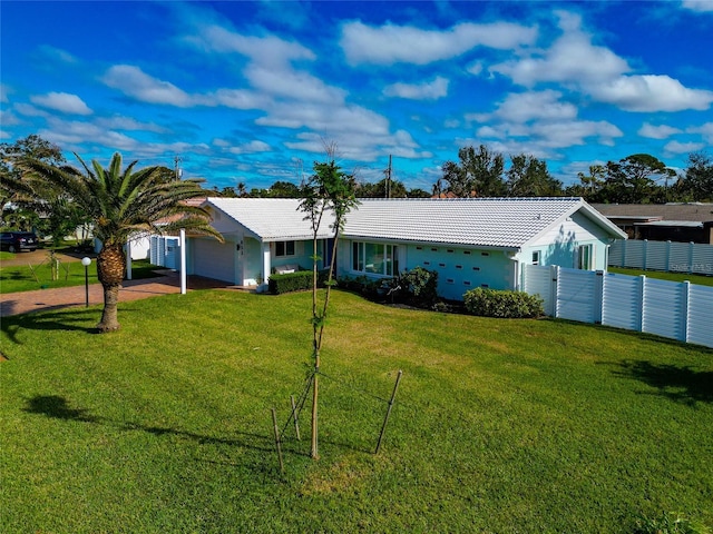 single story home featuring a garage and a front lawn