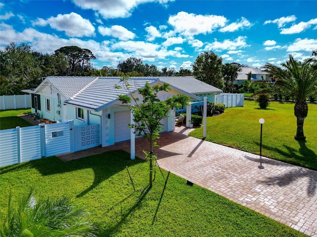 view of front of home featuring a garage and a front yard