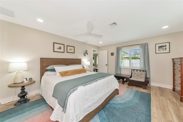 bedroom with light hardwood / wood-style flooring and ceiling fan