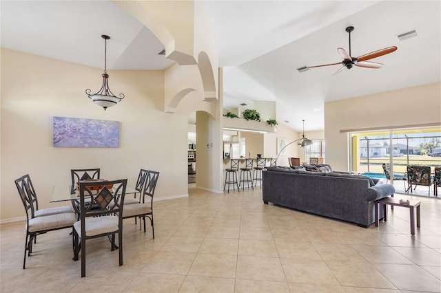 dining room featuring ceiling fan, light tile patterned floors, and high vaulted ceiling