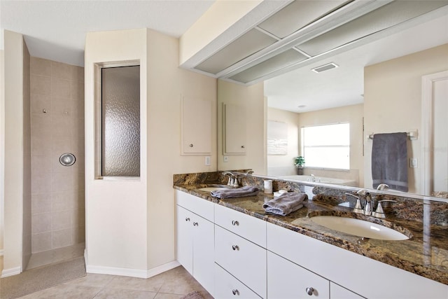 bathroom featuring plus walk in shower, tile patterned flooring, and vanity