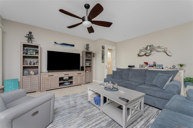 living room with ceiling fan and light tile patterned flooring