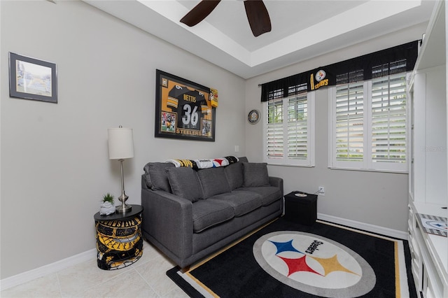 living room with ceiling fan and light tile patterned flooring