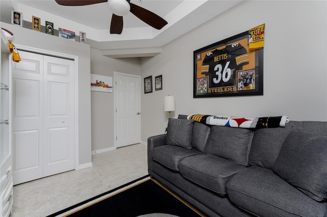 tiled living room featuring ceiling fan