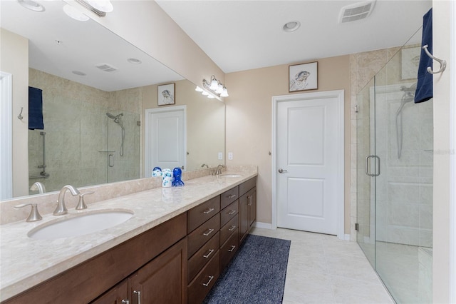 bathroom featuring tile patterned flooring, vanity, and an enclosed shower