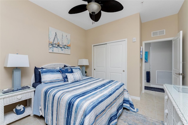 bedroom with light tile patterned floors, a closet, and ceiling fan